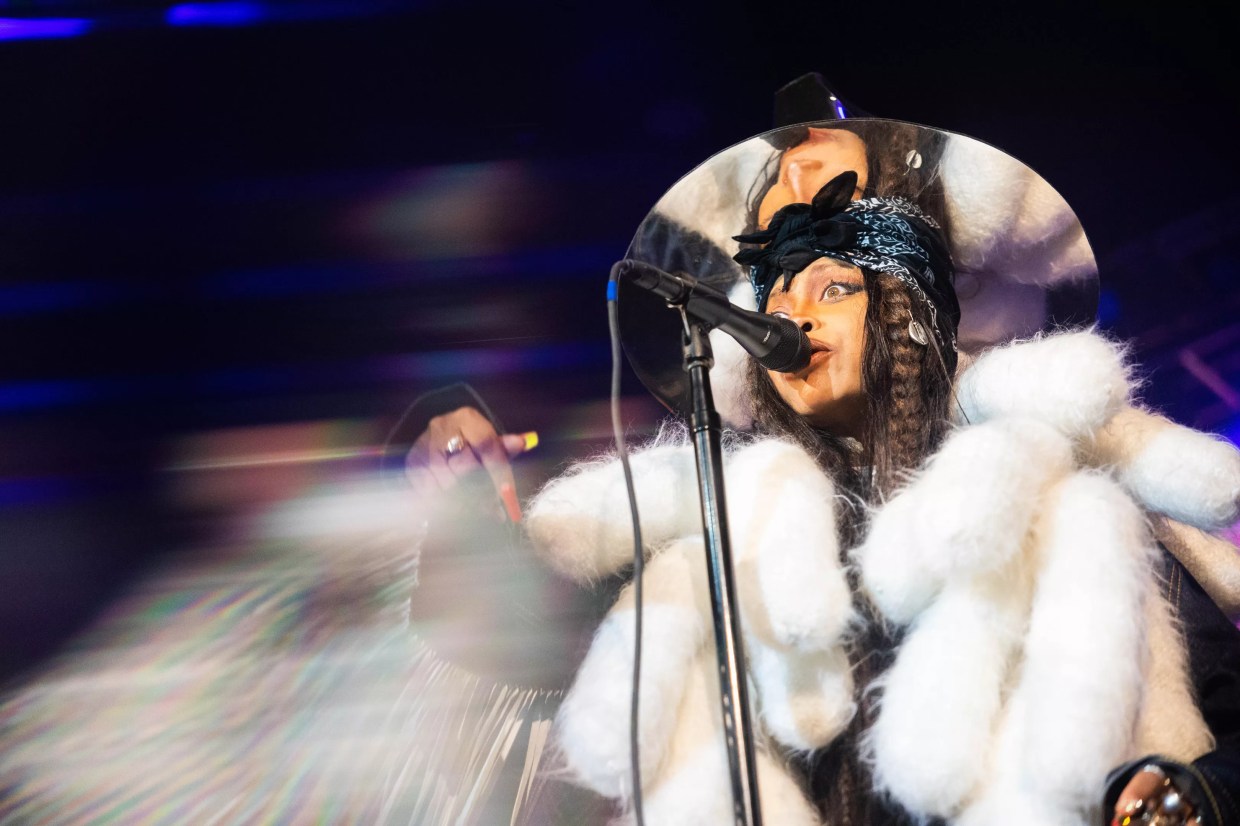 Erykah Badu in a white fur coat, celebrating her birthday bash in her signature mirrored top hat back last February at The Factory.