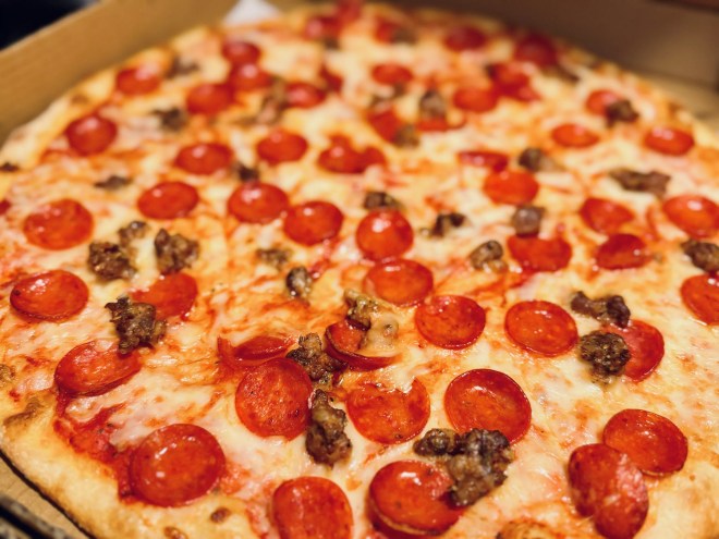 a pepperoni and sausage pizza from good side.