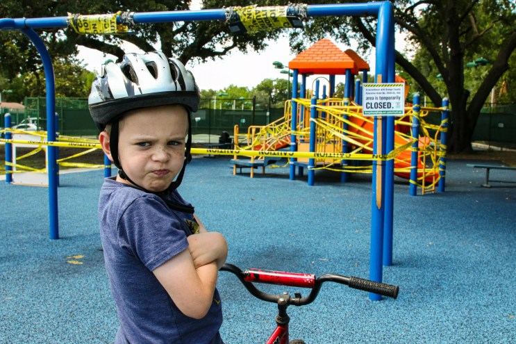 angry kid on bike at playground