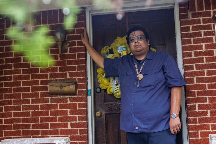 Cristo Mendoza stands in the doorway of his family's home in Southeast Dallas.