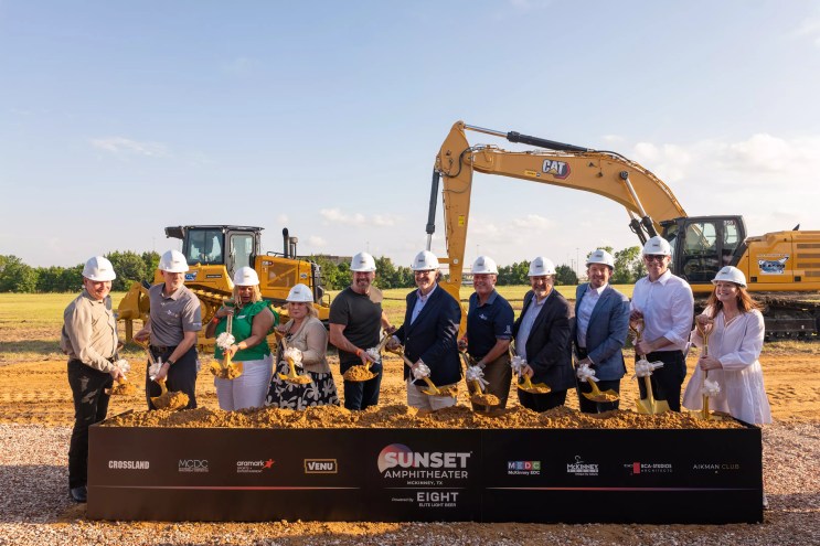 A group of people in front of dirt